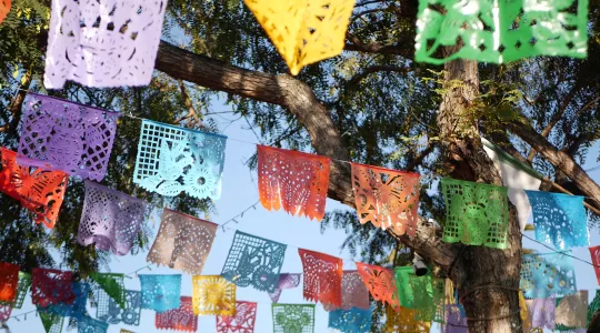 Colorful mexican perforated papel picado banner, festival colourful paper garland.